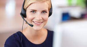 A woman wearing headphones and smiling for the camera.